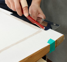 When the paper is pasted, use a ruler to cut the excess paper.